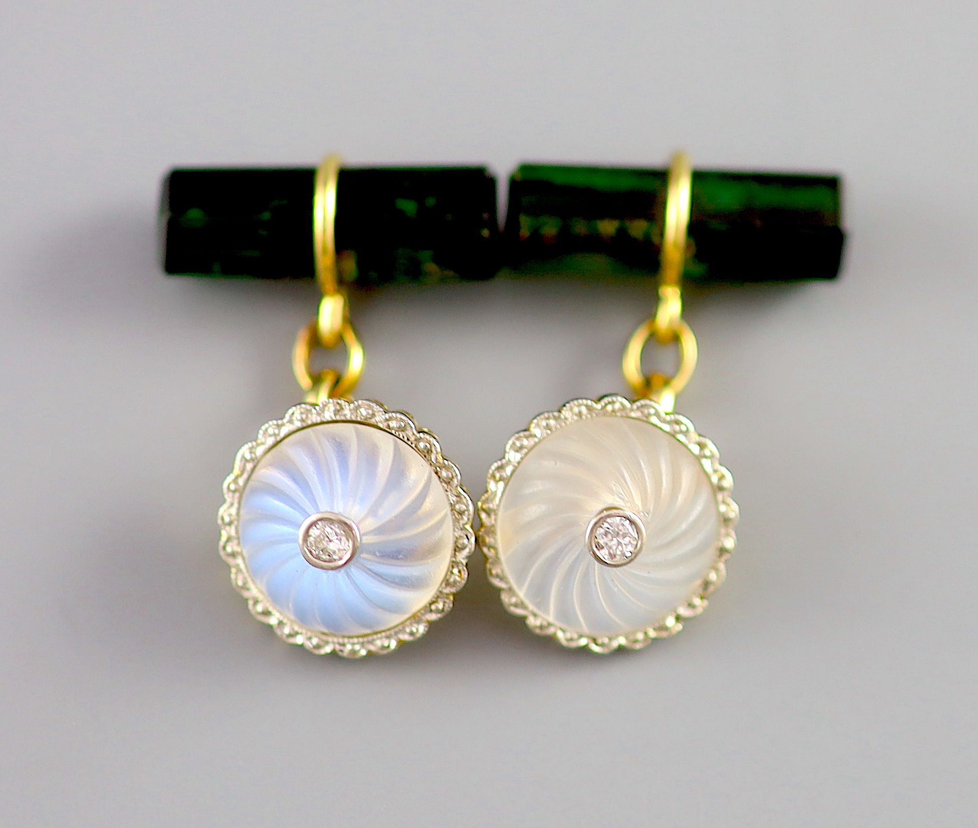 A pair of early 20th century gold, moonstone, diamond and tourmaline set cufflinks